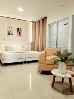 A modern living room with a sofa, a coffee table with a plant, and a wardrobe.