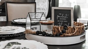 A dining table set with plates, a candle holder, and a framed quote. - Beautiful, Spacious 4-BR  home in Thackerville, OK near Winstar World Casino (Thackerville)