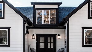 A two-story house with a black front door, two black chairs outside, and a welcome sign. - Beautiful, Spacious 4-BR  home in Thackerville, OK near Winstar World Casino (Thackerville)