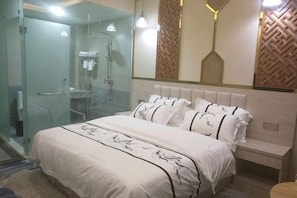 A bedroom with a bed, bedside table, and a walk-in closet.