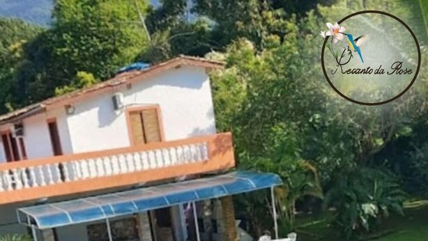 A two-story house with a swimming pool, outdoor furniture, and a garden. - Recanto da Rose Guesthouse (Caraguatatuba)