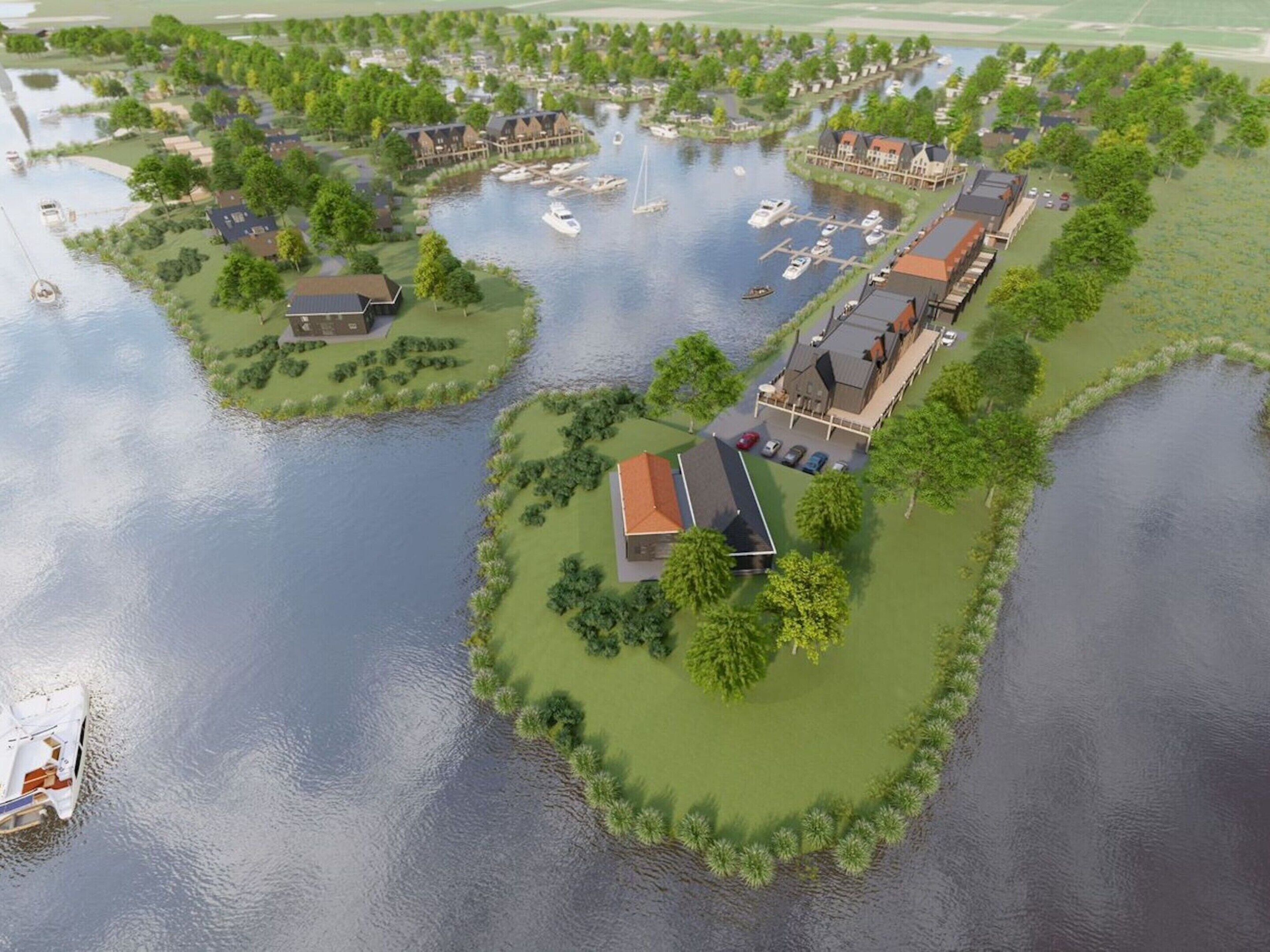 An aerial view of a waterfront property with multiple buildings, a marina with boats, and green spaces.
