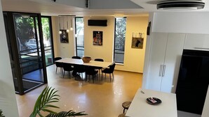 Eine moderne Küche mit Essbereich, großen Fenstern und Blick ins Freie.