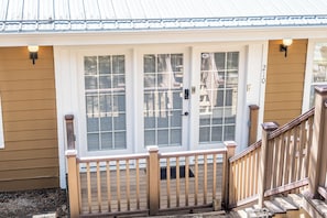 A house with a front porch, a wooden staircase, and a mailbox.