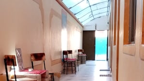 A corridor with tiled flooring, chairs, and a glass ceiling. - hostal beds of salt ga (Uyuni)