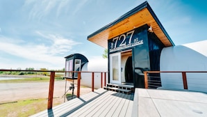 A modern building with a sign reading '727 at The Fly8MA Pilot Lodge.' - Iconic 727 Jet: Private Aft Suite + Lounge (Houston)