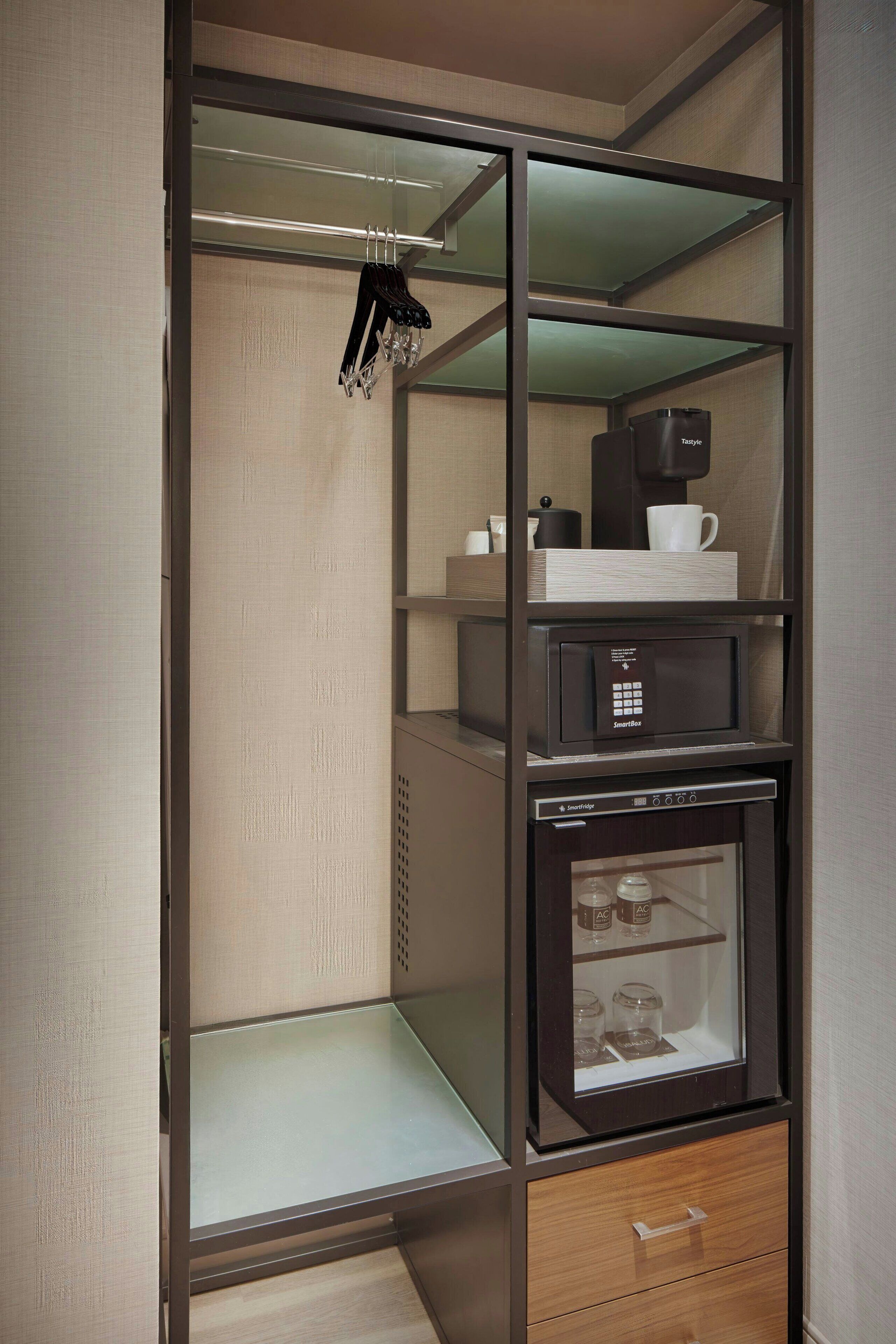 A compact storage unit with shelves, a coffee machine, and a refrigerator.