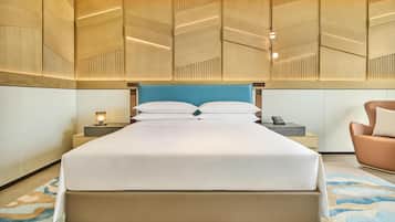 A hotel room with a large bed, bedside tables, a nightstand, a lamp, and a chair.