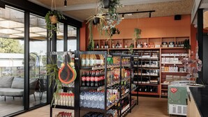 A modern retail space with shelves stocked with beverages, snacks, and other products. - Luxurious Lodge in a Holiday Park (Zwartewaal)