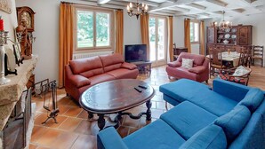 A spacious living room with a fireplace, two sofas, a coffee table, and a television. - Lovely home in Saint-Thurien with WiFi (Saint-Thurien)