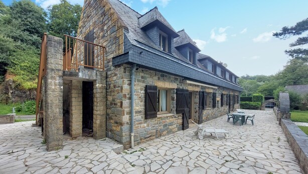 A stone building with a steep roof, large windows, and a stone staircase leading to a balcony. - Lovely home in Saint-Thurien with WiFi (Saint-Thurien)