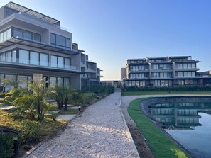 Stunning views of the adjacent water body surround this contemporary building, featuring clean lines and a serene atmosphere.