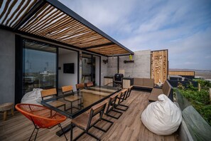 Relax in style with a glass-top dining table and comfortable seating, surrounded by a beautiful view.