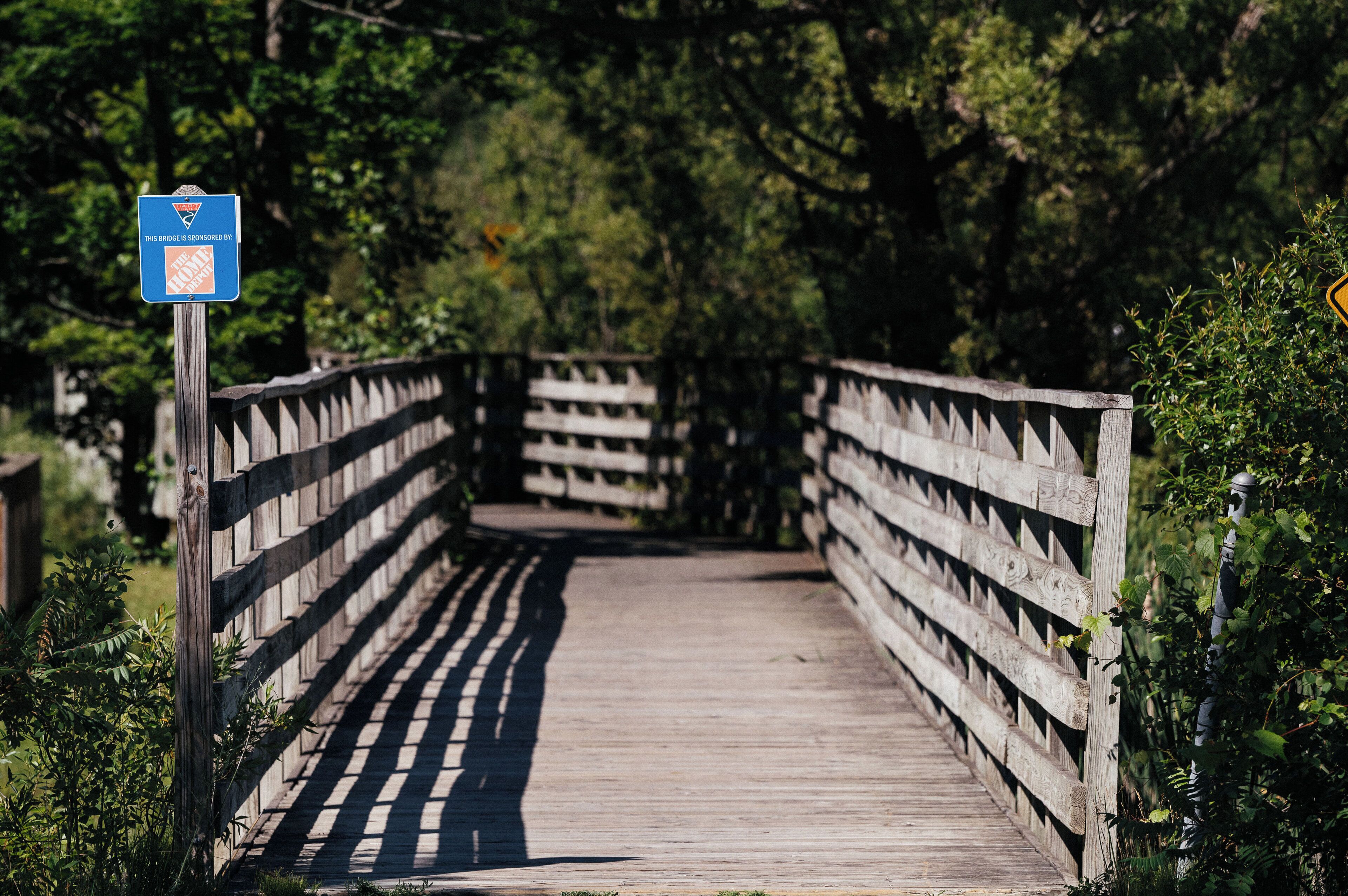 A wooden bridge with a sign indicating it is sponsored by the National Park Service.