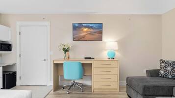 A modern room with a desk, chair, and a bed.