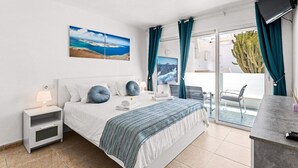 Un dormitorio moderno con cama, mesita de noche y vistas al exterior.