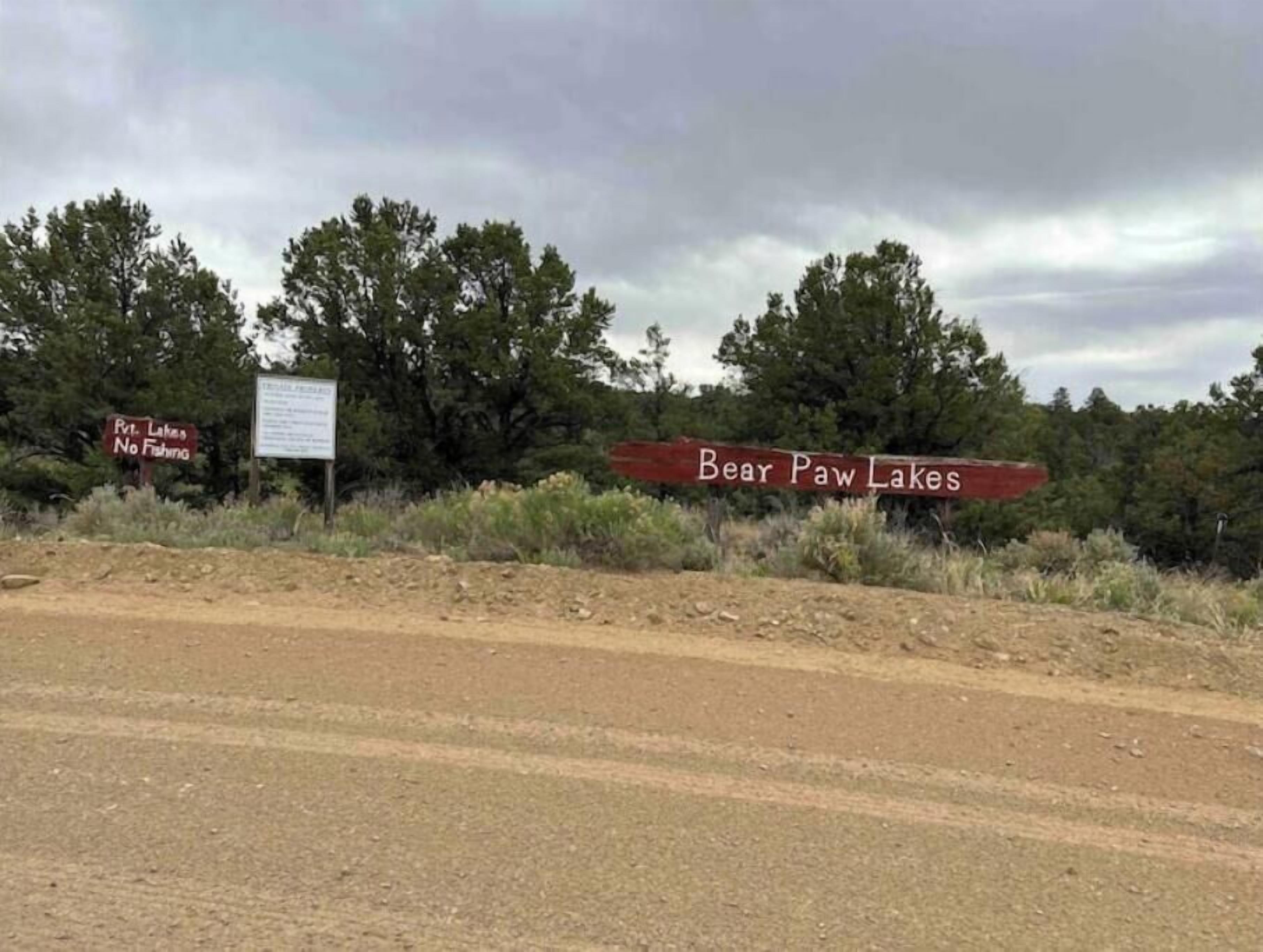 A road sign indicating Bear Paw Lakes with a 'No Fishing' sign nearby.
