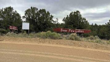 A road sign indicating Bear Paw Lakes with a 'No Fishing' sign nearby.