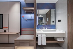 A modern bathroom with a large mirror, white sink, and wooden vanity. - Holiday Inn Express Beijing Mentougou by IHG (Mentougou)