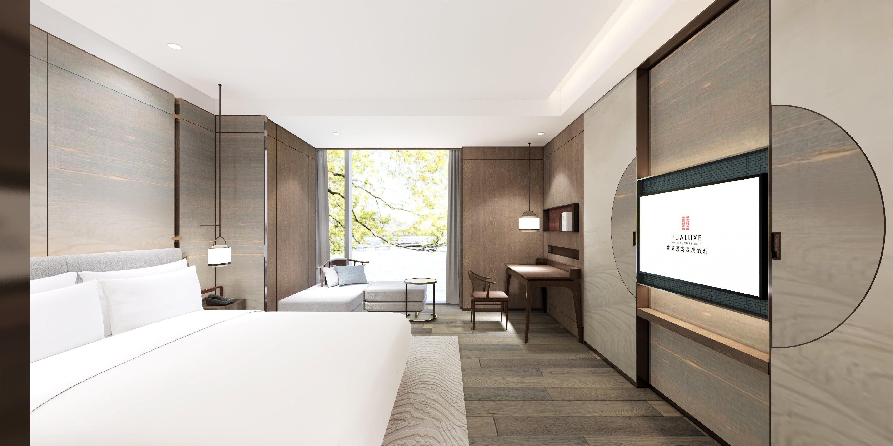 Une chambre d’hôtel moderne, dotée d’un grand lit, d’un bureau et d’une télévision.