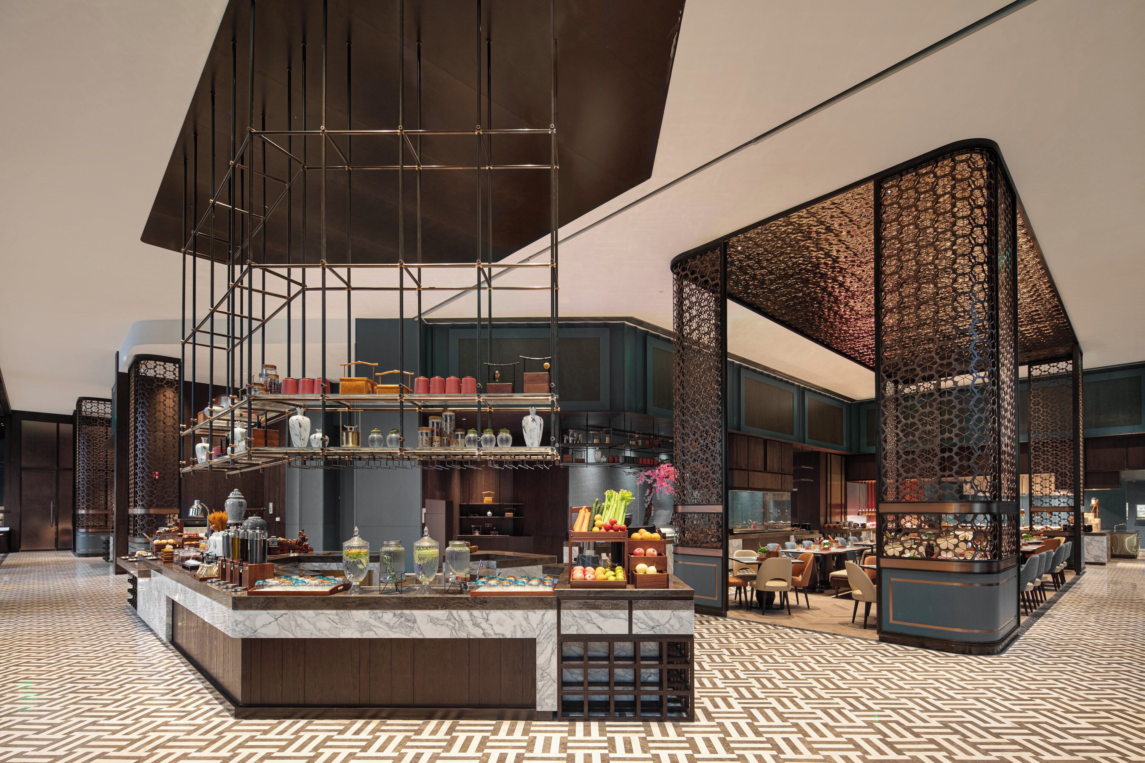 A modern interior with a central bar area, seating arrangements, and decorative elements.