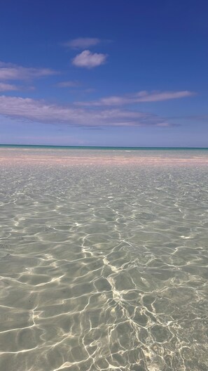On the beach, sun loungers, beach towels