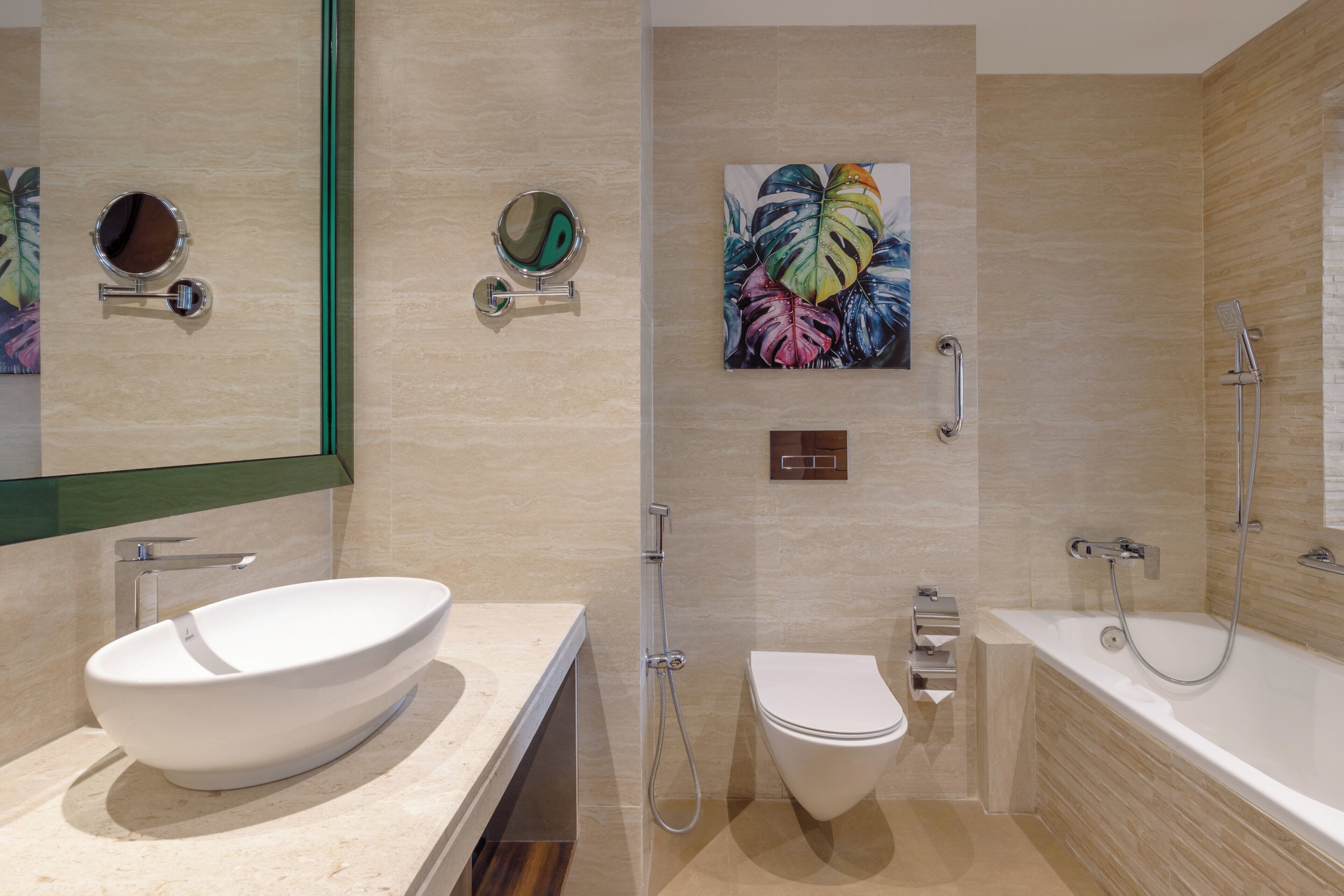 A modern bathroom with a large white sink, a toilet, a bathtub, and a shower.