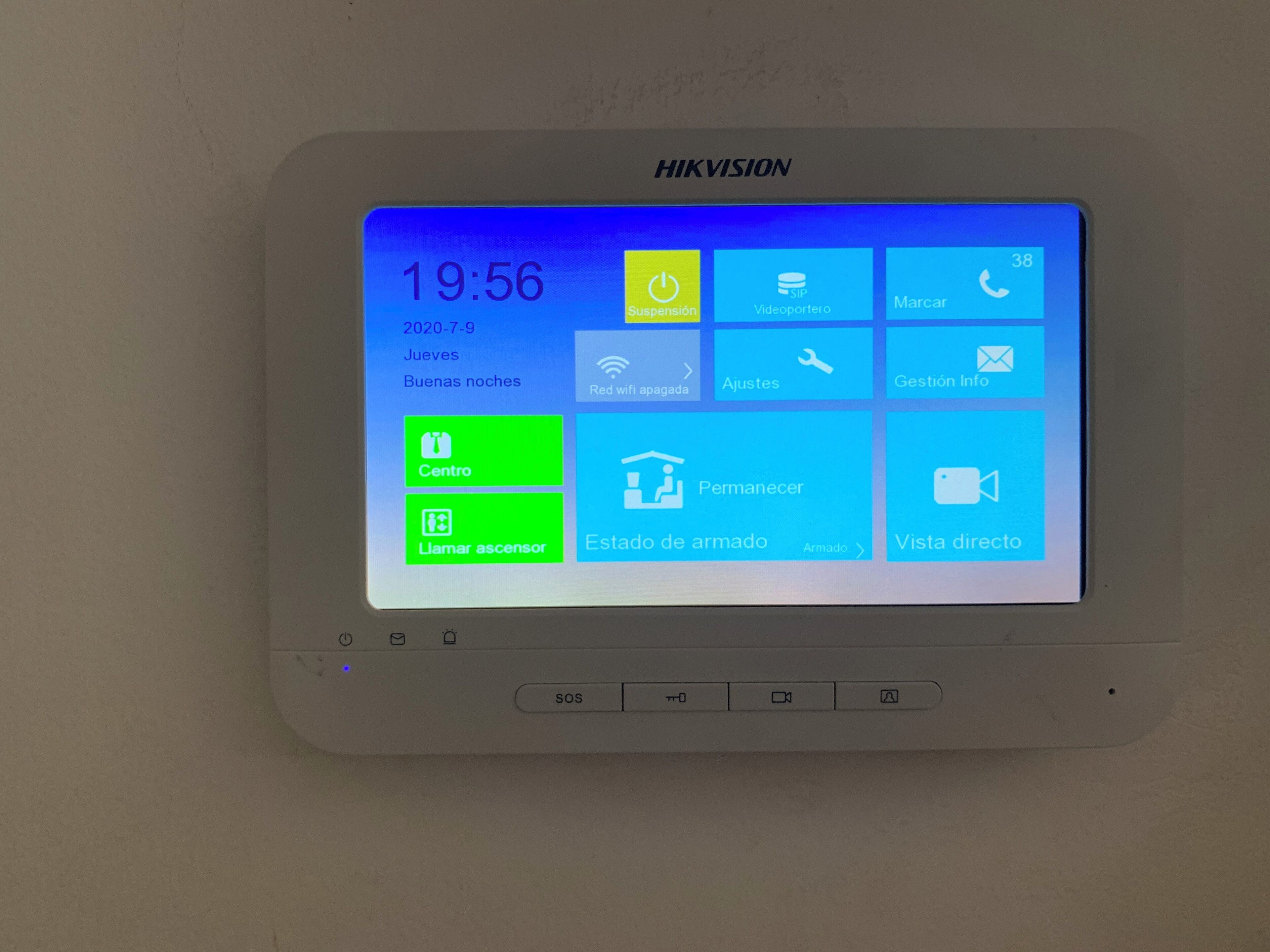 A HIKVISION security camera mounted on a wall, displaying the time, date, and various control options.