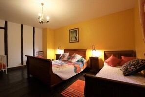 Cozy bedroom with a double bed, floral-patterned duvet, and wooden headboard.