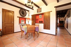 Enjoy meals with family and friends in this cozy dining area, complete with a wooden table and matching chairs.