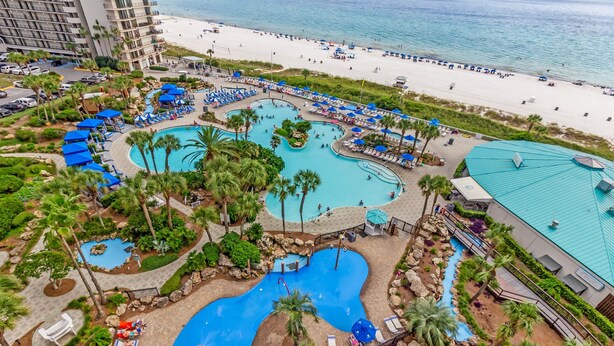 A resort with multiple swimming pools, beach access, and palm trees. - Sailor's Delight 🌊 Deluxe 2-BR Condo @ Edgewater Beach & Golf Resort - Tower 1 (Panama City Beach)