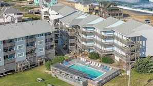 A coastal hotel with multiple balconies, a swimming pool, and ocean views. - 7081- Sea View - Rodanthe Condo | Coastal Beach Escape (Rodanthe)
