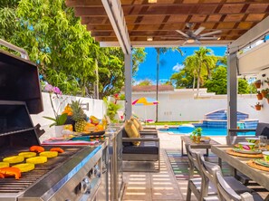 An outdoor patio with a grill, seating, and a pool. - Villa Palma: Heart of Miami | 5 min to Miracle Mile (Miami)