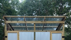 A metal-framed structure with a corrugated exterior and a wooden roof. - 2 Queen-Bed Canvas Bell Tent on Working Farm in Historic Laurel Highlands (Smithfield)