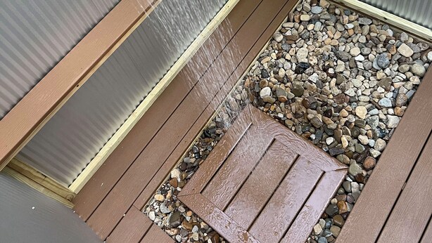A wooden deck with a metal grate and a water feature. - 2 Queen-Bed Canvas Bell Tent on Working Farm in Historic Laurel Highlands (Smithfield)