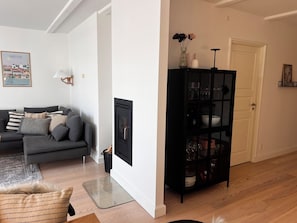 A living room with a grey sofa, a black cabinet, and a framed picture on the wall. - Luxury holiday home with sea view (Gråsten)