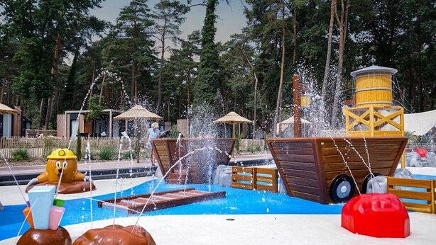 A water play area with a ship-shaped water feature and a yellow character statue. - Nice Chalet With Dishwasher, Maastricht at 16 km (Zutendaal)