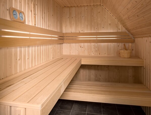 A sauna with wooden benches and a tiled floor. - Villa by Lake Veerse Meer With Sauna and Terrace (Wolphaartsdijk)