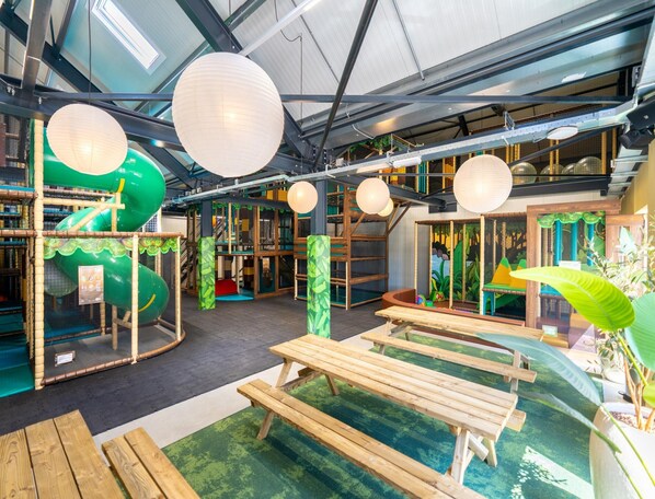 A play area with slides, tables, and hanging lanterns. - Villa by Lake Veerse Meer With Sauna and Terrace (Wolphaartsdijk)