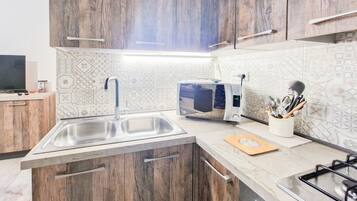 Fridge, stovetop, high chair, cookware/dishes/utensils