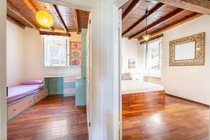 A room with a bed, a desk, and a window.