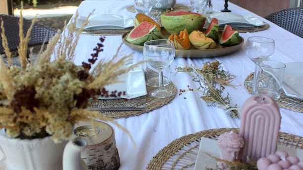 An outdoor dining area with a table set for a meal, surrounded by natural elements and decor. - Villa 'A Suara' with Mountain View, Private Pool and Private Terrace (Canale-di-Verde)