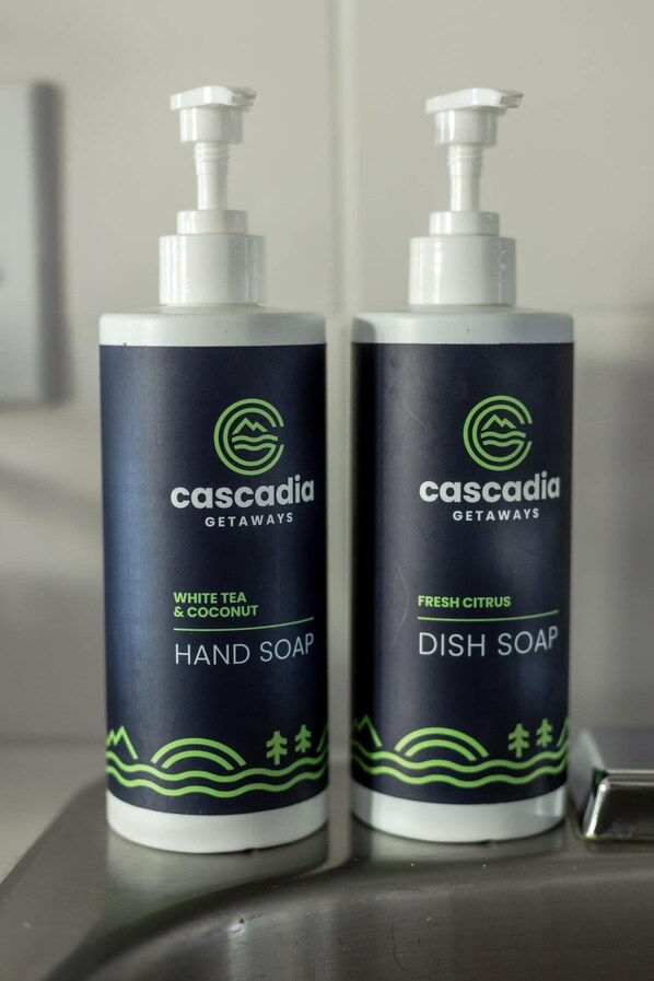 Two bottles of Cascadia Getaways hand and dish soap.