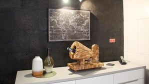 A reception desk with a world map, a cork sculpture, and a telephone. - House 37North (Ponta Delgada)