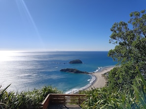 A coastal view with a beach, ocean, and a small island. - Best position in Mt Maunganui, quiet yet central. 300 m from beach & Pilot Bay (Mount Maunganui)