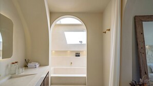 A modern bathroom with a white vanity, a large mirror, and a skylight. - Villa Eyla (Canggu)