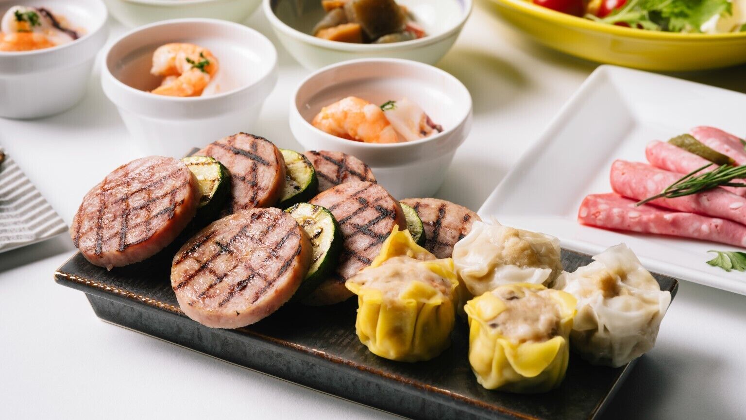 A variety of grilled meats and dumplings on a plate.