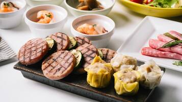 A variety of grilled meats and dumplings on a plate.