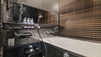 A modern bathroom with a large bathtub, a vanity with a mirror, and a shower area.