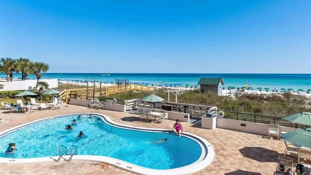 A swimming pool with a view of the beach and ocean.